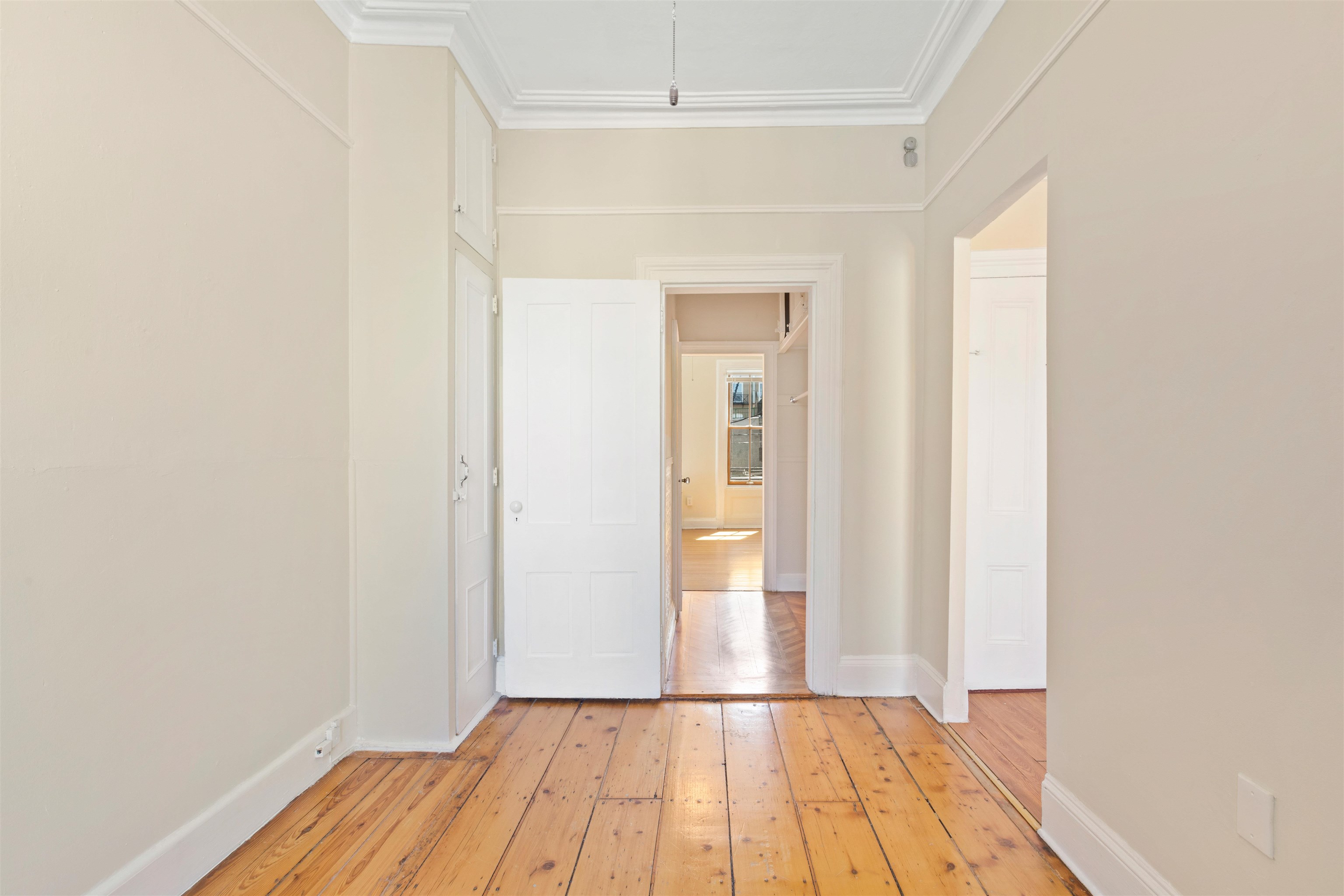 804 Bloomfield Street, Unit 2 Hoboken, NJ 07030 - Photo 9 of 14 a view of a hallway with wooden floor and a bathroom