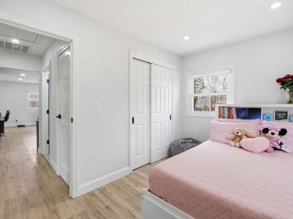 63 Jasper Street Saugus, MA 01906 - Photo 22 of 39 a bedroom with a bed and wooden floor