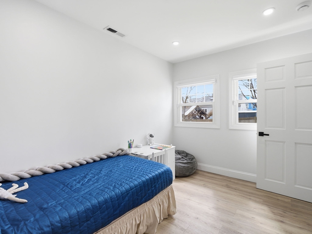 63 Jasper Street Saugus, MA 01906 - Photo 24 of 39 a bedroom with a bed and wall painting