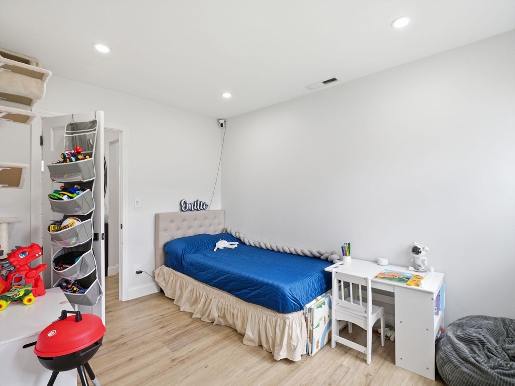 63 Jasper Street Saugus, MA 01906 - Photo 25 of 39 a bedroom with furniture and a chair