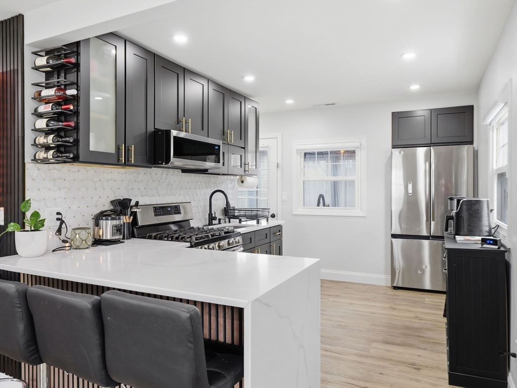63 Jasper Street Saugus, MA 01906 - Photo 3 of 39 a kitchen with stainless steel appliances a sink stove and refrigerator