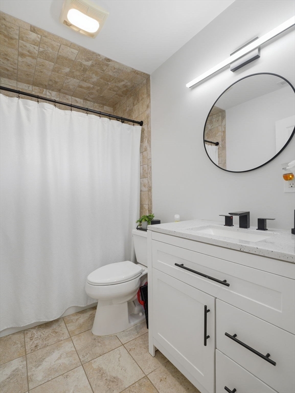 63 Jasper Street Saugus, MA 01906 - Photo 31 of 39 a bathroom with a toilet a sink and mirror