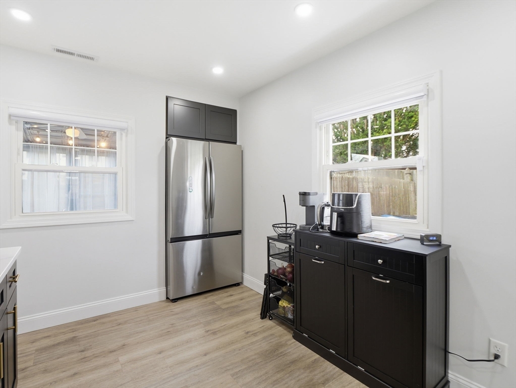63 Jasper Street Saugus, MA 01906 - Photo 5 of 39 a kitchen with a refrigerator a stove a sink and a window