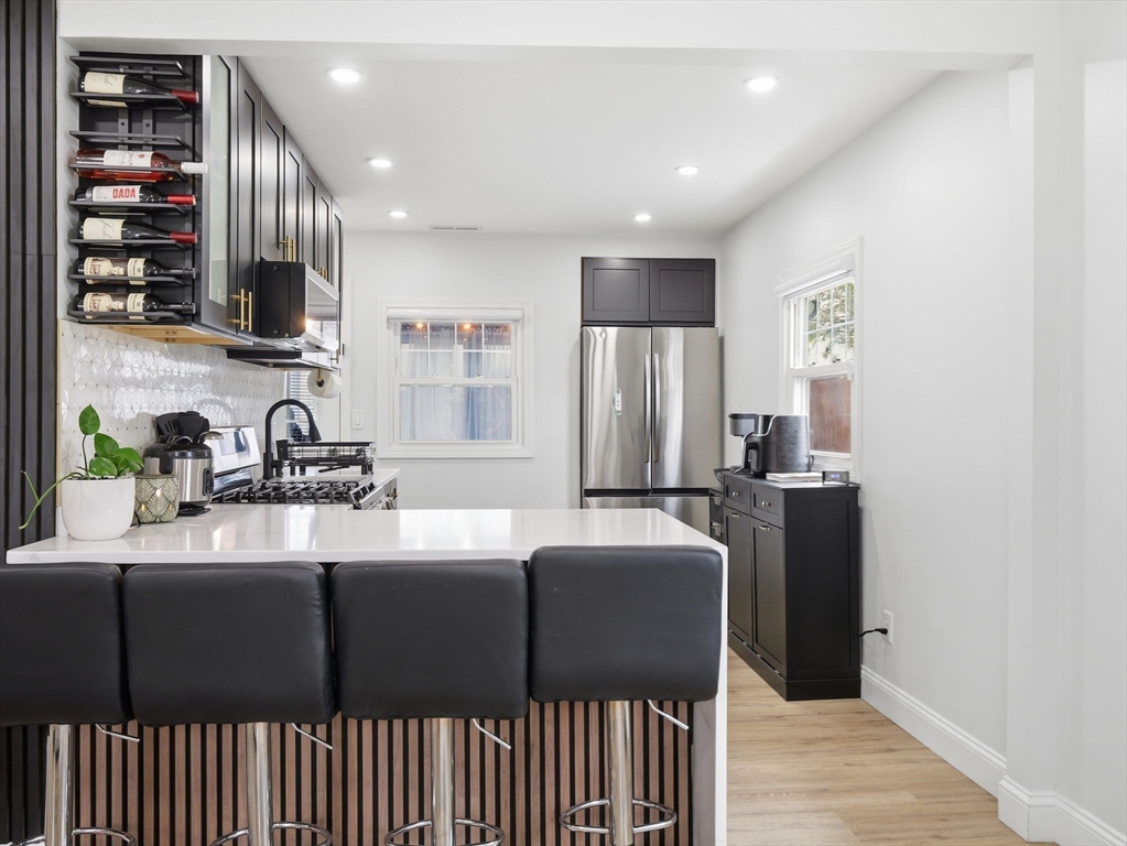 63 Jasper Street Saugus, MA 01906 - Photo 7 of 39 a kitchen with stainless steel appliances granite countertop a refrigerator and a sink