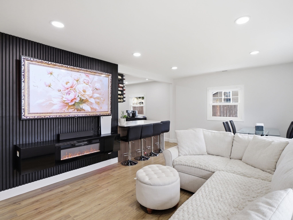 63 Jasper Street Saugus, MA 01906 - Photo 10 of 39 a living room with furniture and a flat screen tv