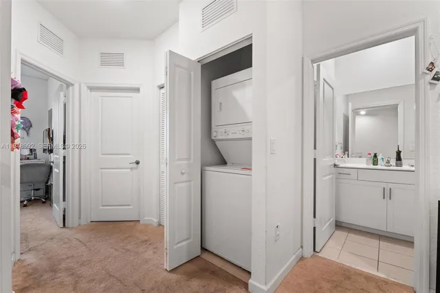 a view of bathroom with a sink mirror and cabinets