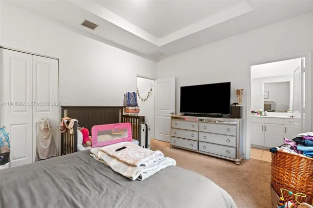 a bedroom with a bed and flat screen tv