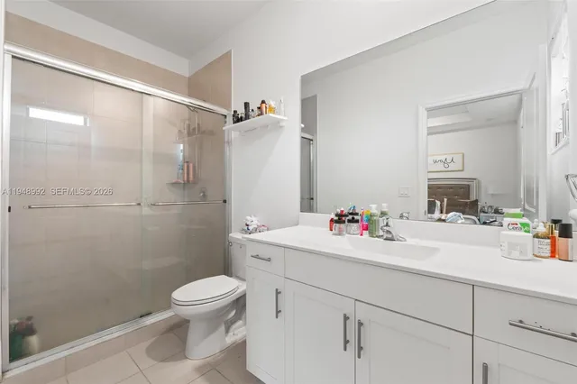 a bathroom with a sink mirror toilet and shower
