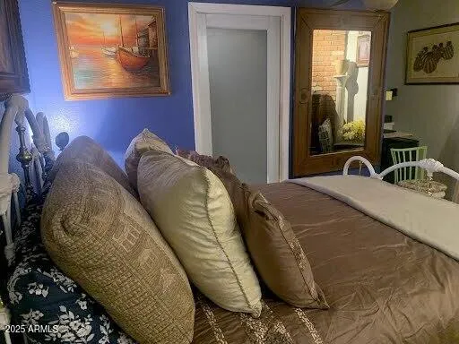 a bed room with a bed and a painting on the wall