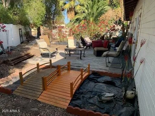 a view of a backyard with sitting area