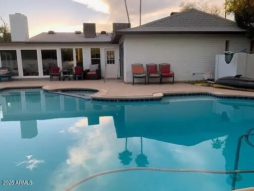 a swimming pool with outdoor seating