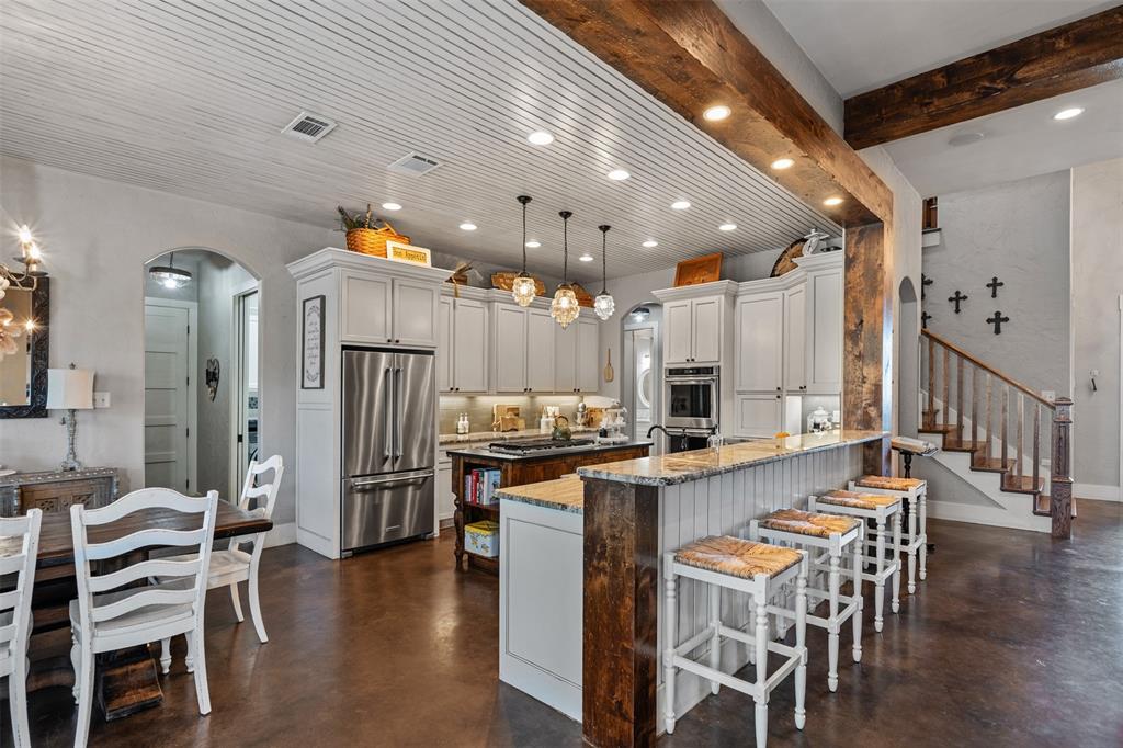 107 Nautical Point Mabank, TX 75143 - Photo 11 of 36 a kitchen with stainless steel appliances a dining table chairs stove and cabinets
