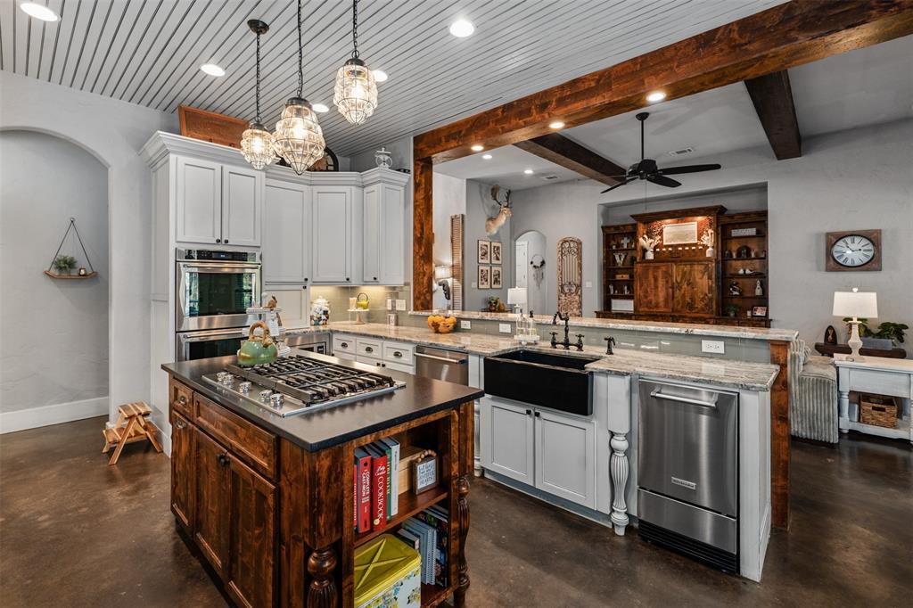 107 Nautical Point Mabank, TX 75143 - Photo 12 of 36 a kitchen with stainless steel appliances granite countertop a stove and a view of dining room