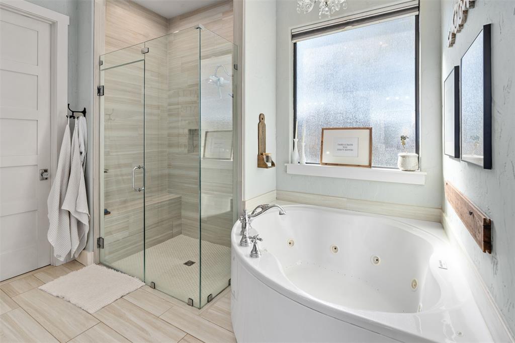 107 Nautical Point Mabank, TX 75143 - Photo 19 of 36 a bathroom with a bathtub and a shower