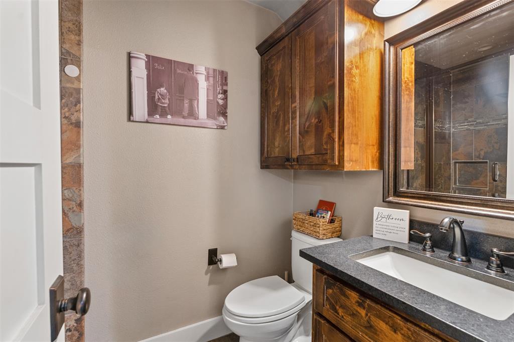 107 Nautical Point Mabank, TX 75143 - Photo 28 of 36 a bathroom with a granite countertop sink mirror vanity and toilet