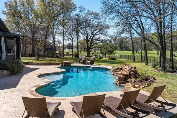 a view of a swimming pool with a patio