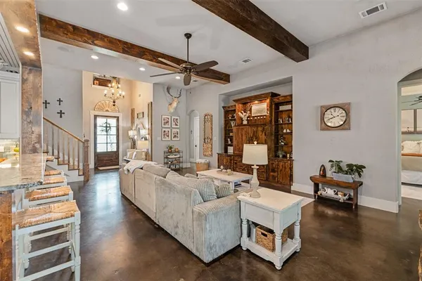 a living room with furniture and a chandelier