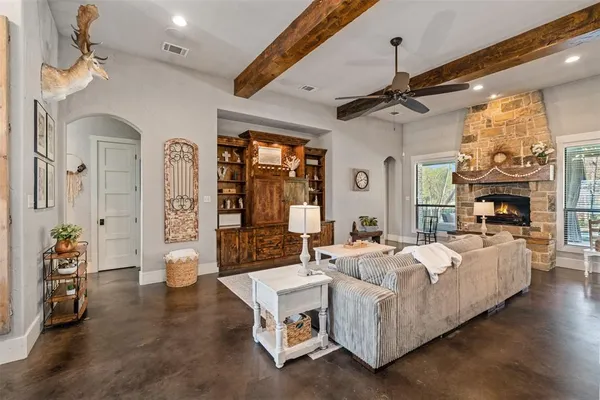 a living room with furniture fireplace and a chandelier
