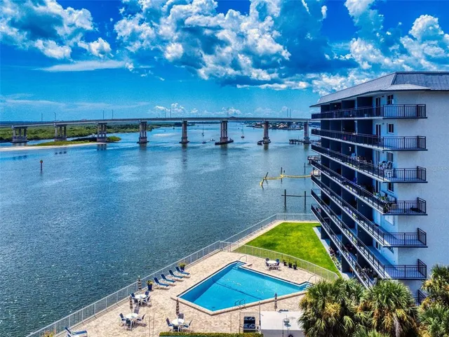 a view of a pool with a lounge chairs