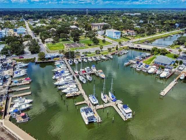 an aerial view of water body with boats and residential houses with outdoor space