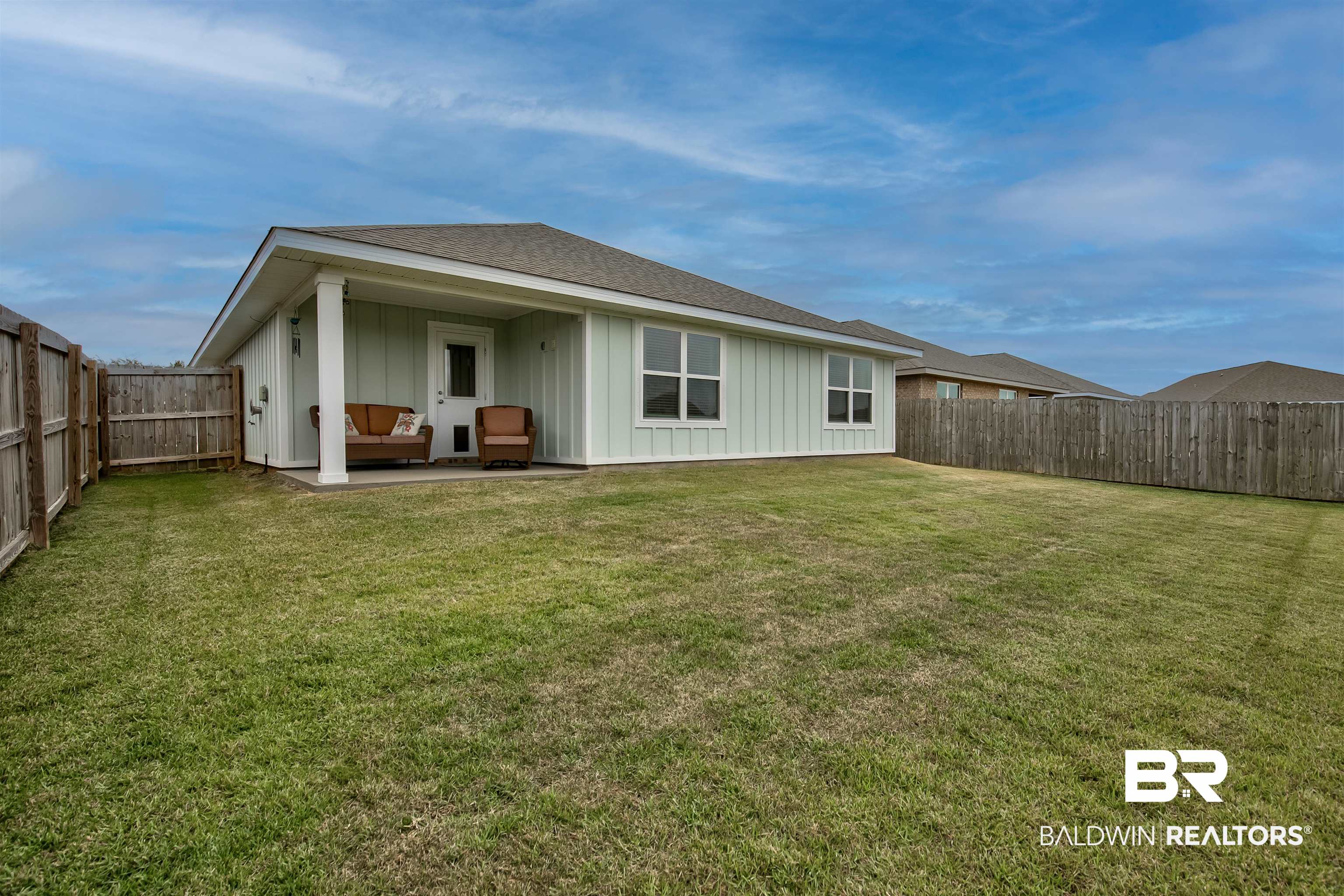 8033 Irwin Loop Daphne, AL 36526 - Photo 37 of 38 Expansive green lawn with privacy fencing and a rear patio