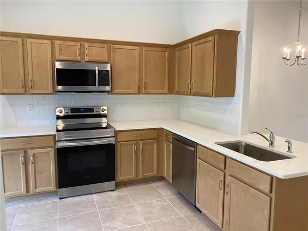 a kitchen with a stove a microwave and a sink