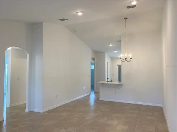 a view of an empty room with window and cabinet