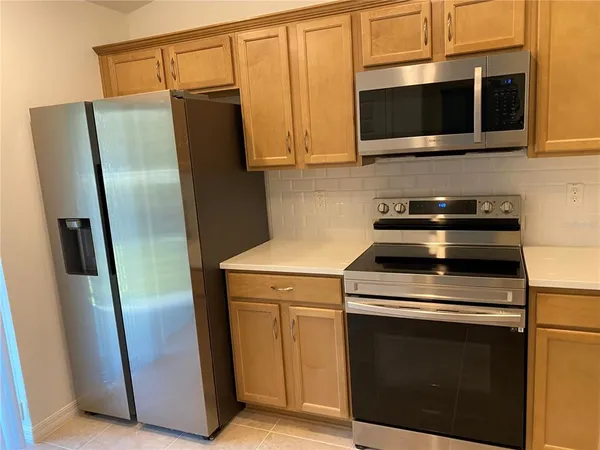 a kitchen with stainless steel appliances granite countertop a sink and a stove