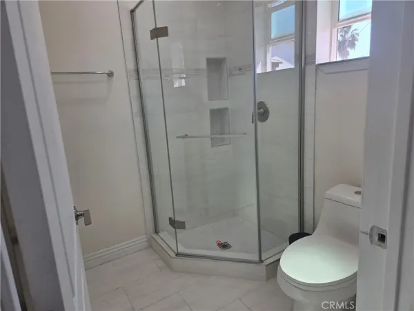 an empty room with wooden floor and closet