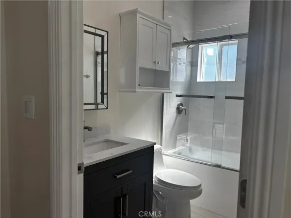 a bathroom with a glass shower door