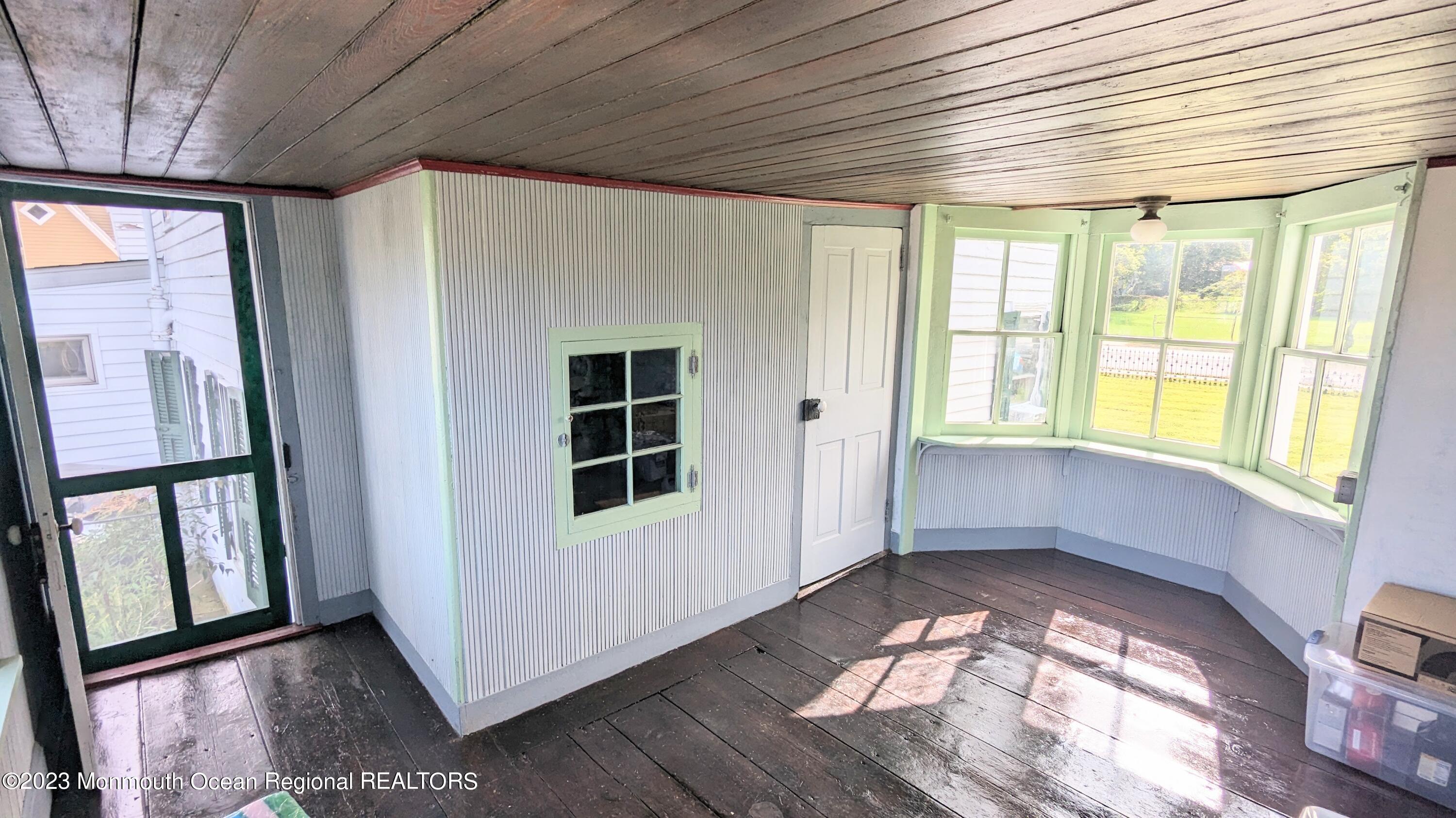 303 Baptist Road Newport, NJ 08345 - Photo 15 of 20 a view of an empty room with wooden floor and a window