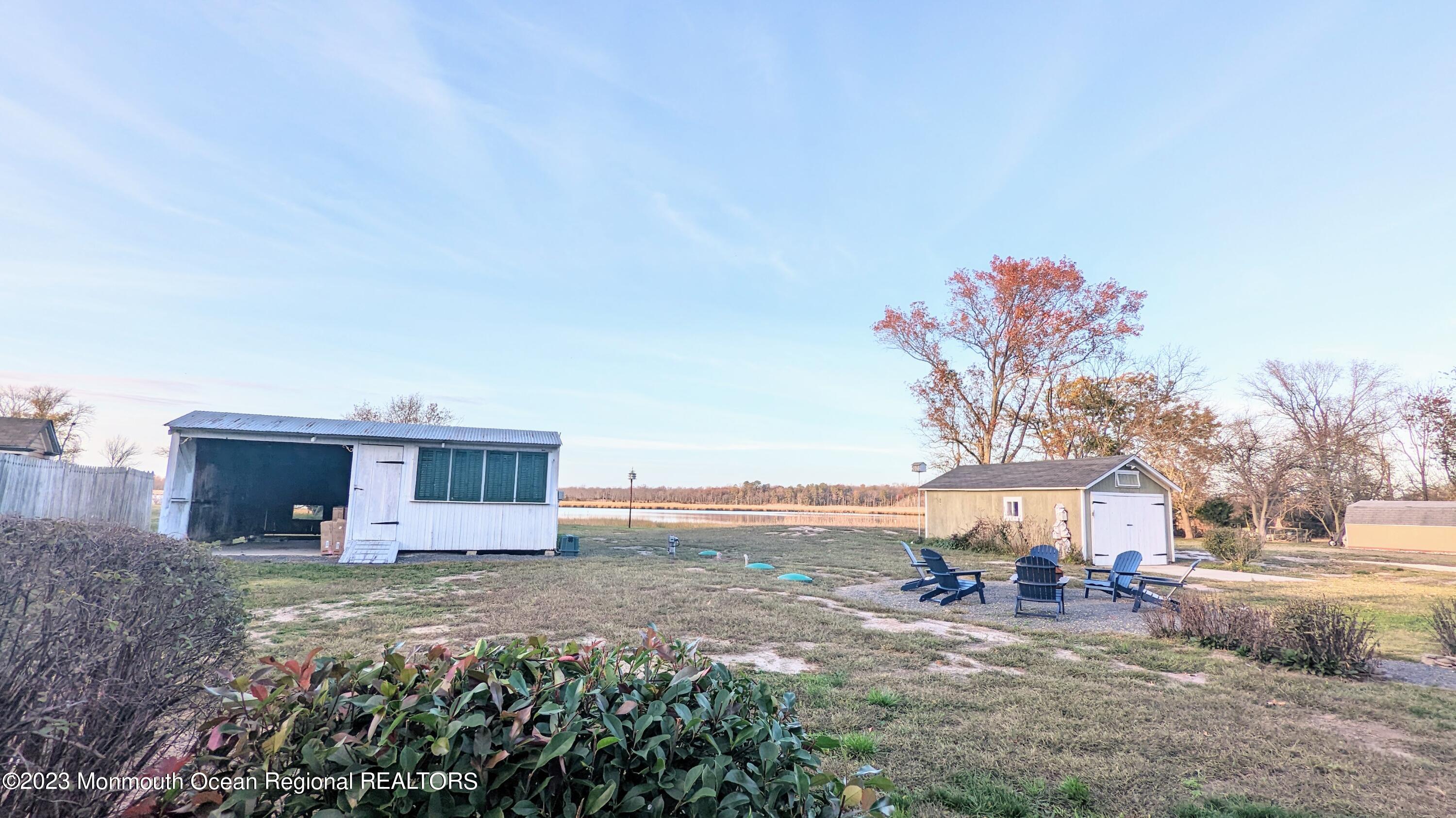 303 Baptist Road Newport, NJ 08345 - Photo 20 of 20 a view of a house with patio and a garden