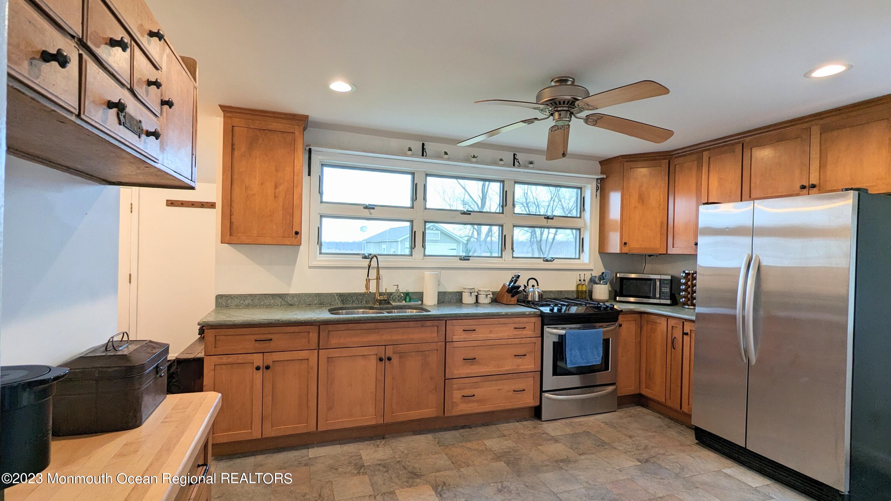 303 Baptist Road Newport, NJ 08345 - Photo 8 of 20 a kitchen with granite countertop a sink stove and refrigerator
