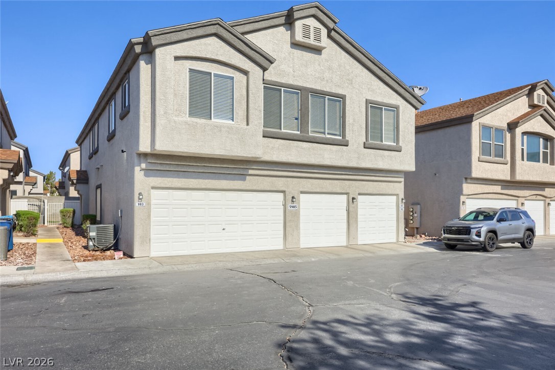5985 High Steed Street, Unit 101 Henderson, NV 89011 - Photo 34 of 38 A well-maintained multi-unit residence features integrated garages and a sturdy stucco exterior.