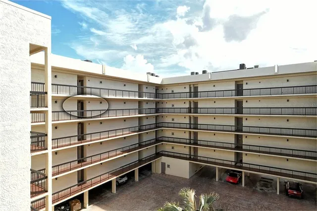 a view of a swimming pool with lounge chairs