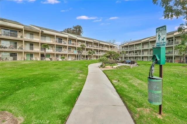a front view of a building with a garden