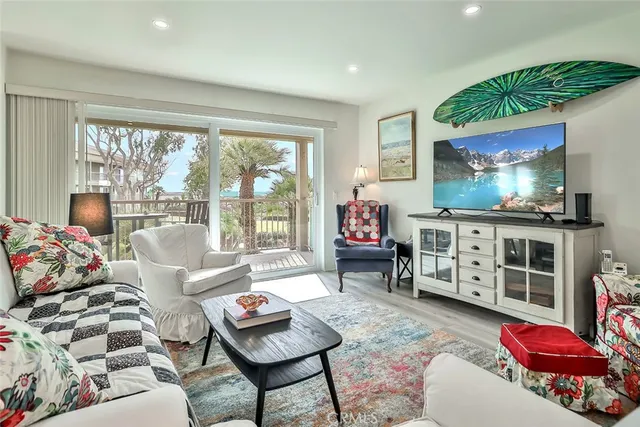 a living room with furniture cabinets and a flat screen tv
