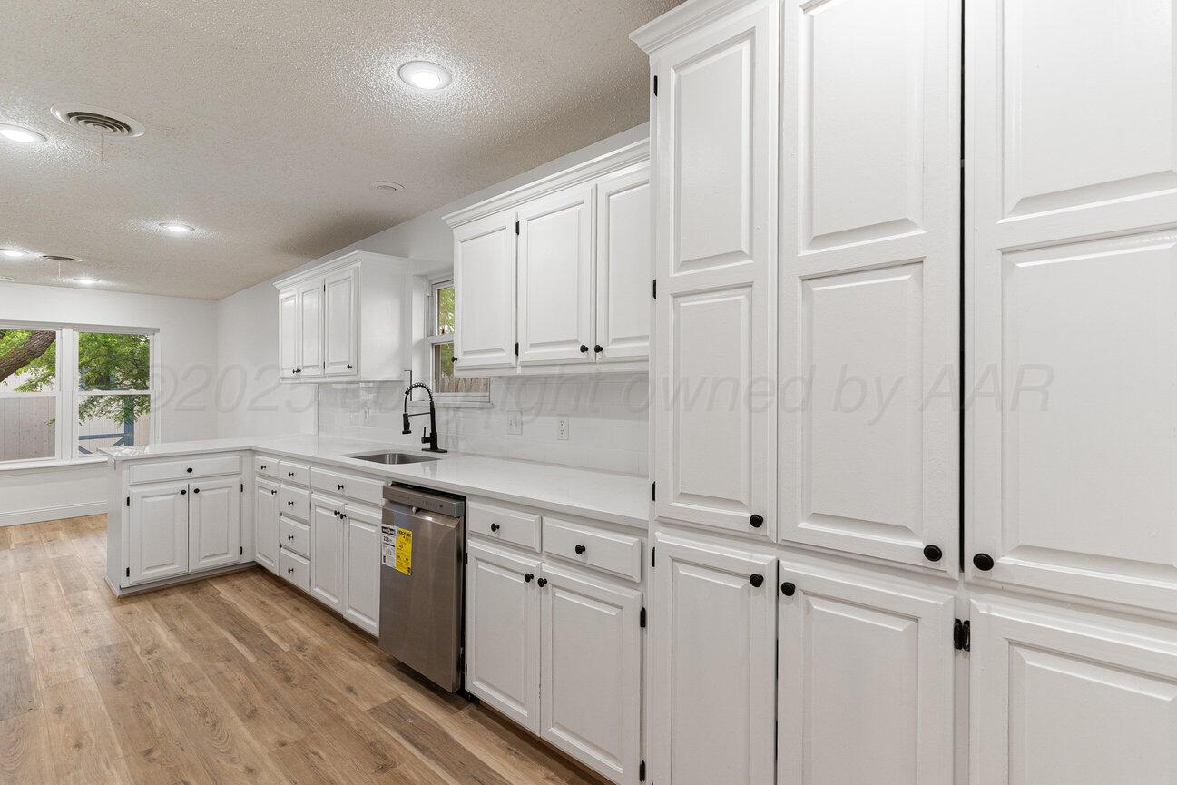 2607 15th Avenue Canyon, TX 79015 - Photo 22 of 54 a kitchen with white cabinets and white appliances