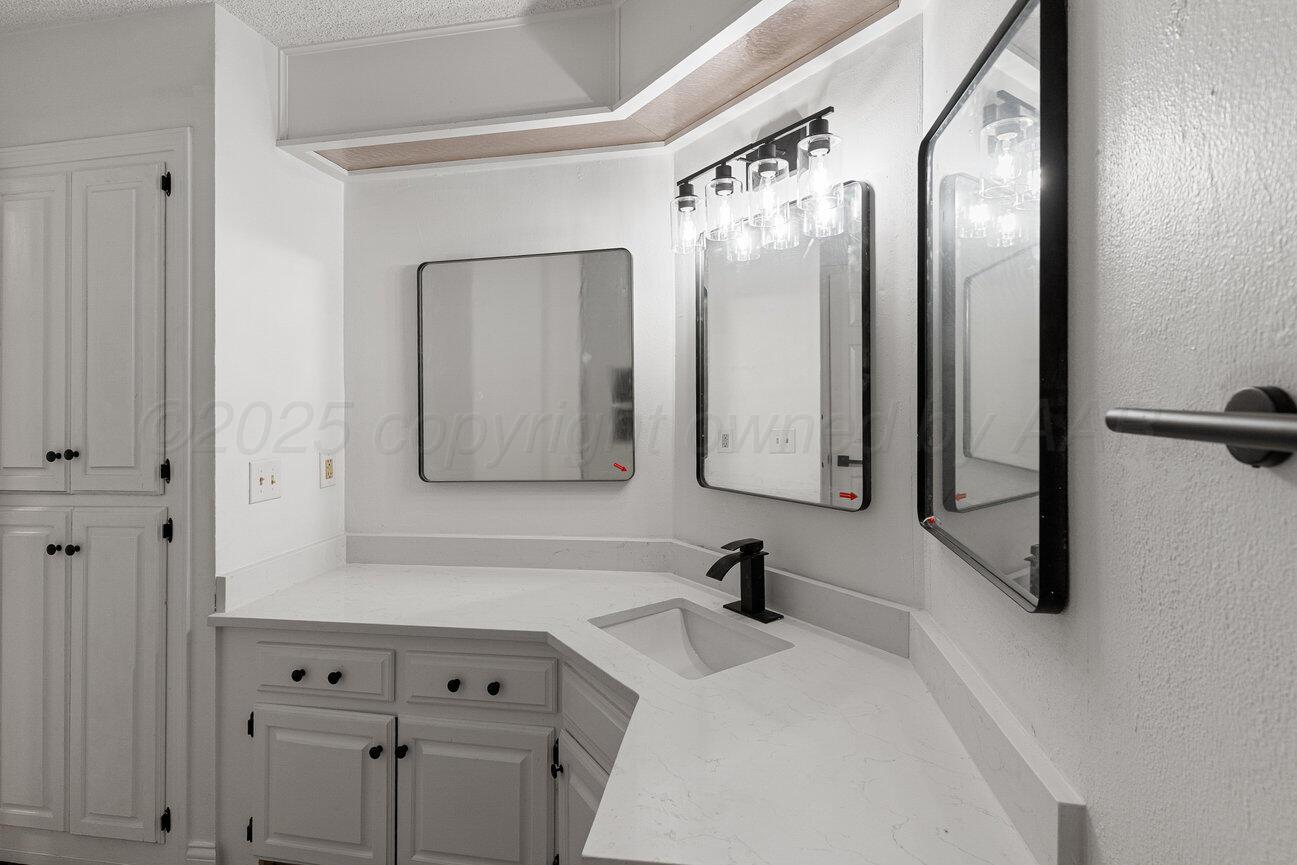 2607 15th Avenue Canyon, TX 79015 - Photo 24 of 54 a bathroom with a double vanity sink