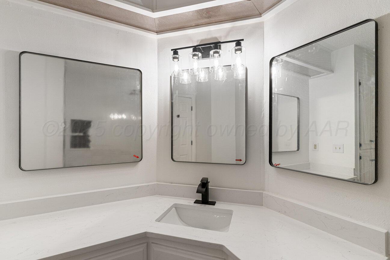 2607 15th Avenue Canyon, TX 79015 - Photo 25 of 54 a bathroom with a sink and a mirror