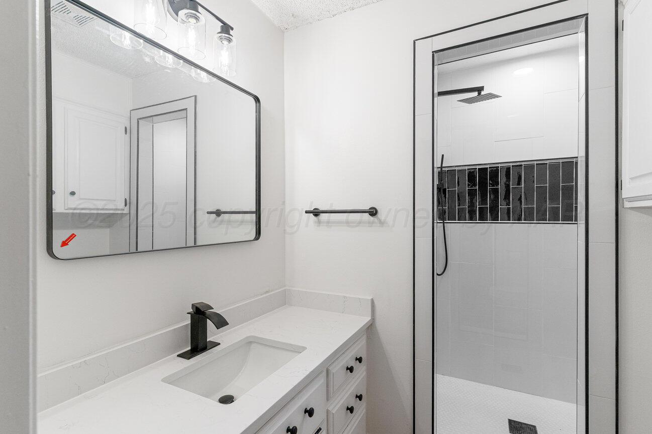 2607 15th Avenue Canyon, TX 79015 - Photo 27 of 54 a bathroom with a sink and mirror
