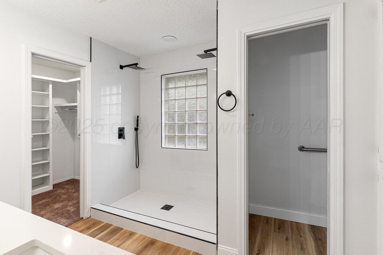 2607 15th Avenue Canyon, TX 79015 - Photo 30 of 54 a bathroom with a glass shower door and a window
