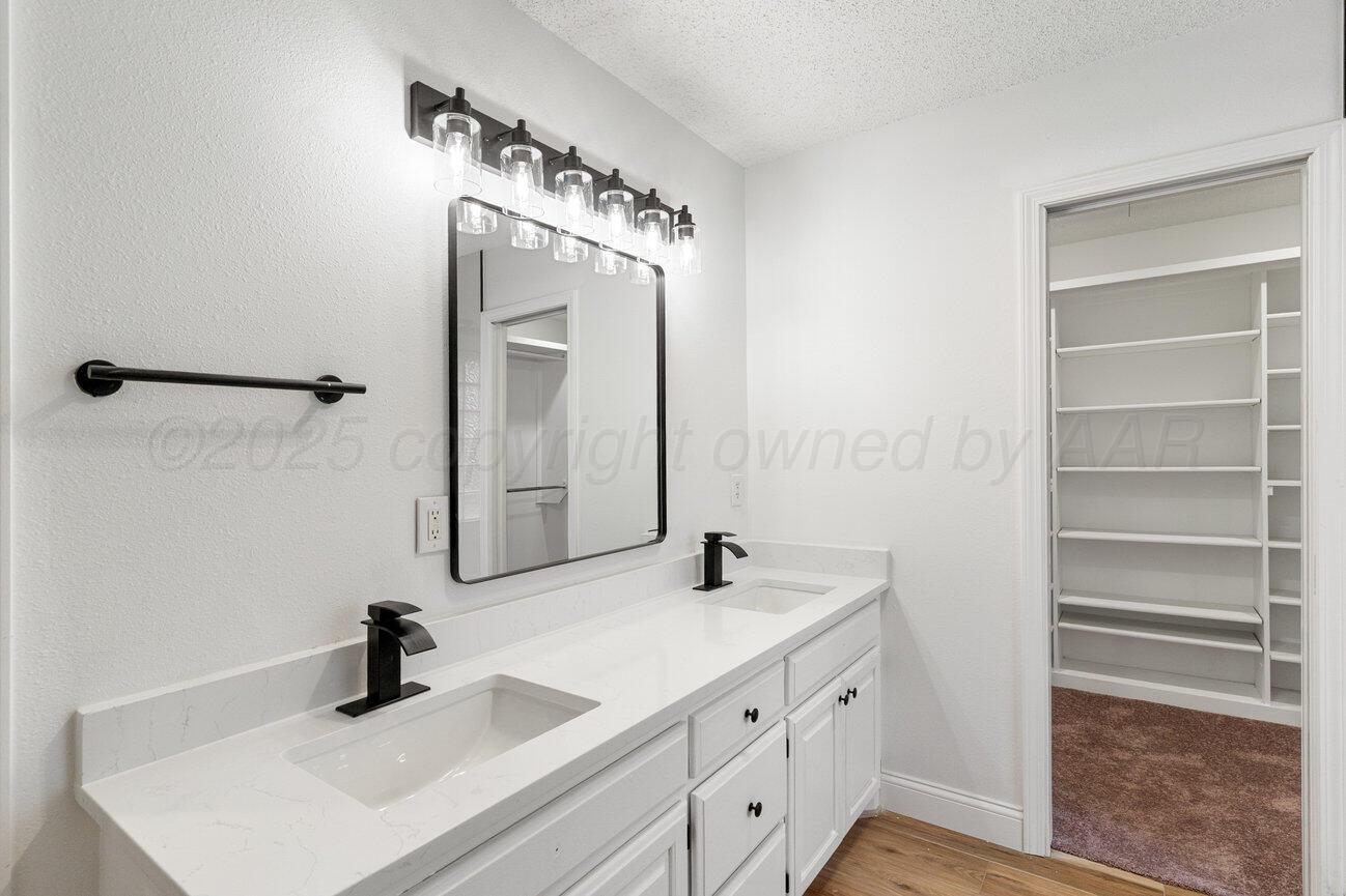 2607 15th Avenue Canyon, TX 79015 - Photo 32 of 54 a bathroom with a double vanity sink mirror and
