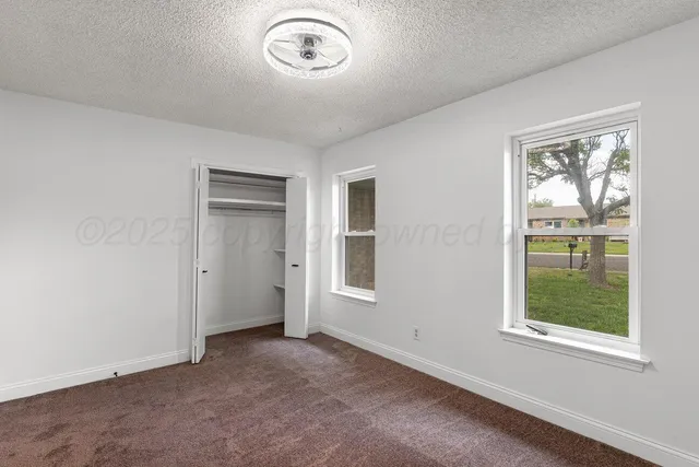 an empty room with a empty space and windows