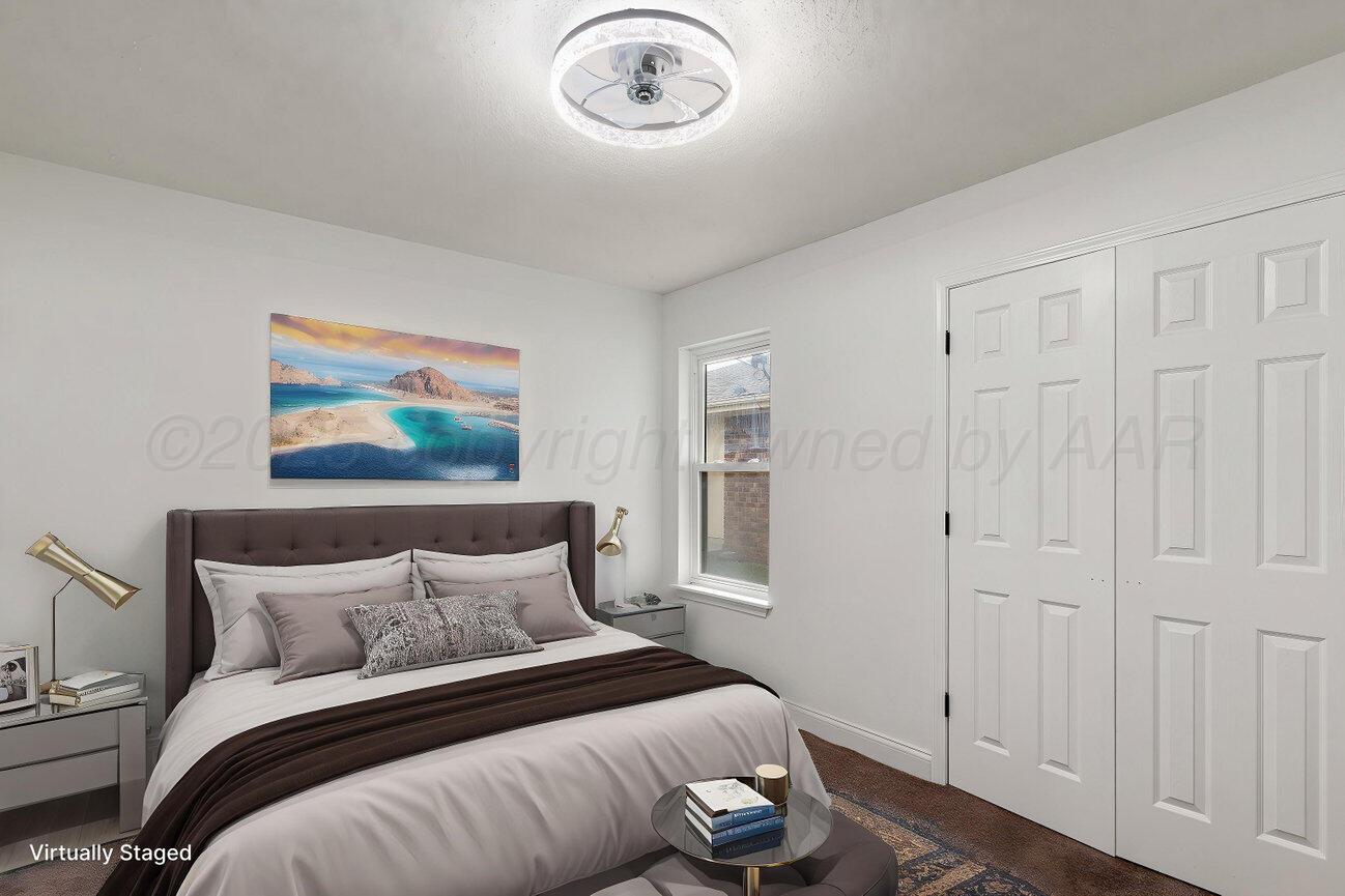 2607 15th Avenue Canyon, TX 79015 - Photo 45 of 54 a bedroom with a bed and a chandelier