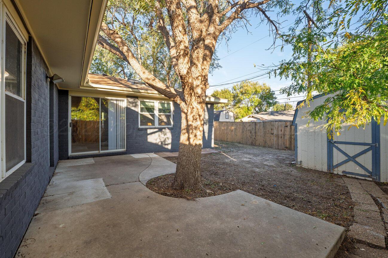 2607 15th Avenue Canyon, TX 79015 - Photo 7 of 54 a view of a house with a tree and a yard