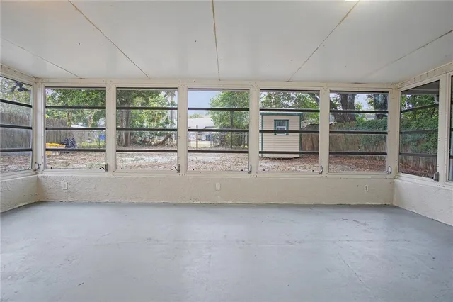 a view of an empty room with windows