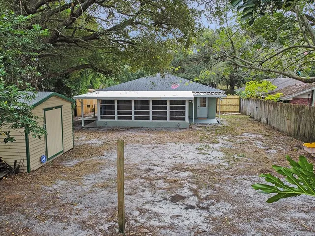 a view of a house with a yard and sitting area