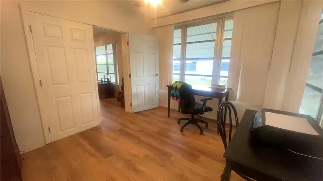 a view of a workspace with furniture and a window