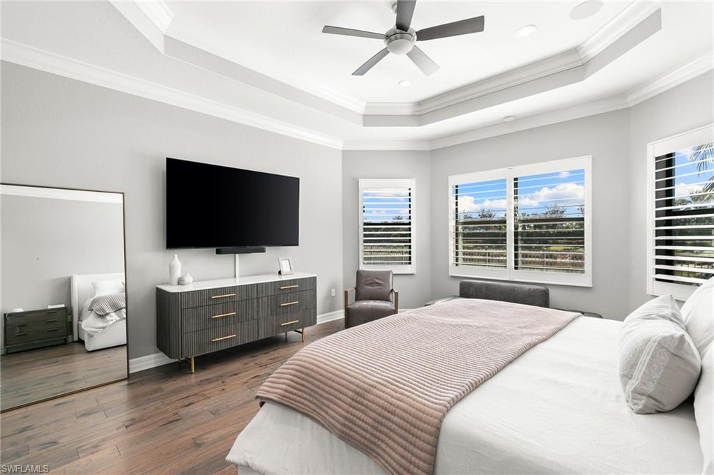 4308 Caldera Circle Naples, FL 34119 - Photo 19 of 44 a bedroom with a flat screen television and a bed